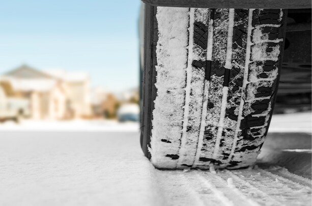 How to prepare your Volkswagen for the winter season in Richmond, VA at West Broad VW | Close up of tires filled with snow and parked on a snowy road