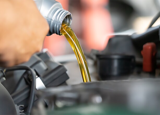 How to prepare your Volkswagen for the winter season in Richmond, VA at West Broad VW | Person poruing in new engine oil into engine