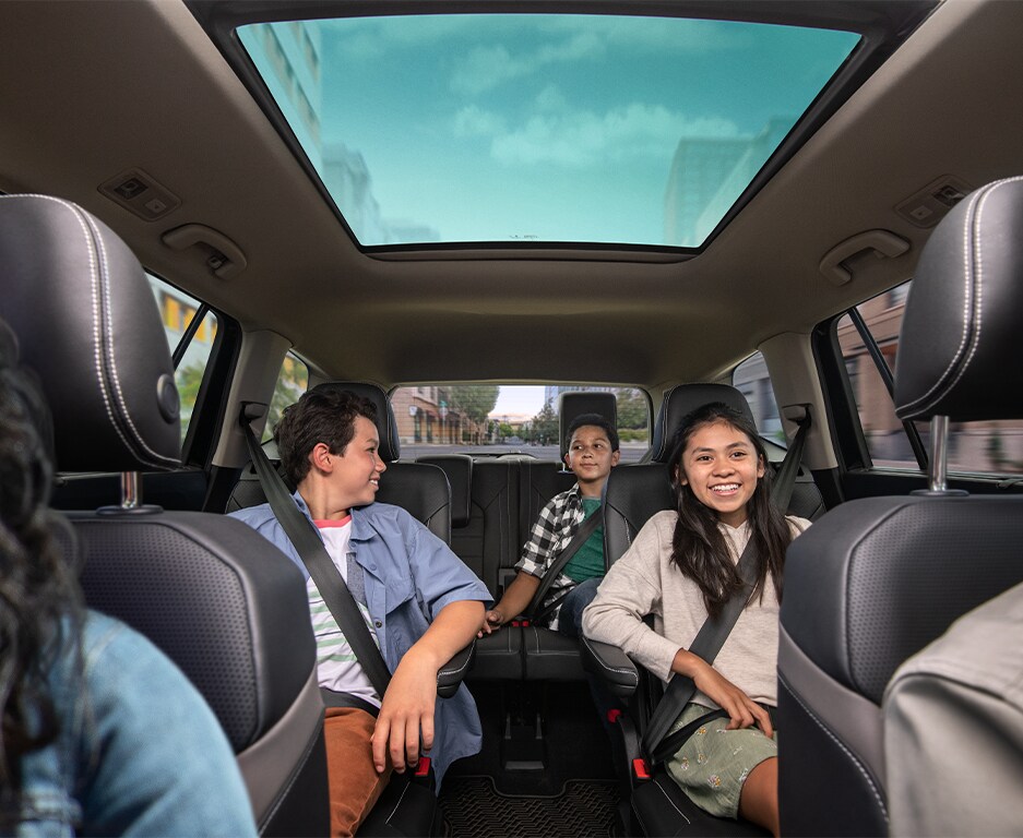 Model Features of the 2022 Volkswagen Atlas at West Broad Volkswagen | Interior view of the back seat rows along with kids happily sitting together