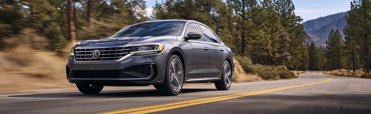Basic Car Maintenance and Servicing Checklist | West Broad Volkswagen | 2021 Volkswagen Passat Driving Down a Road with a Treeline and Mountains in the Background