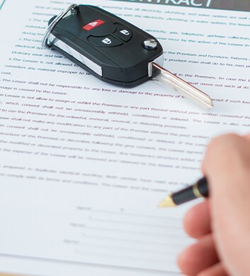 Defining GAP Insurance at West Broad Volkswagen in Richmond, VA | Person signing contract with car keys laying on top