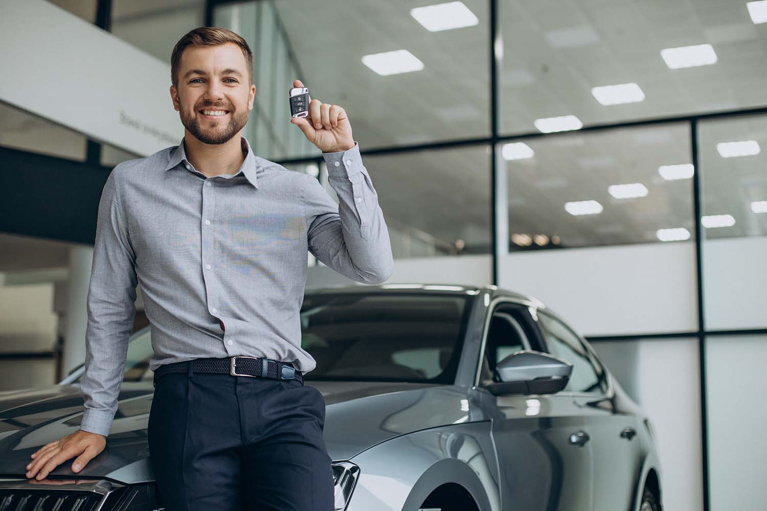 High Cost of Replacing a Car Key | West Broad Volkswagen | Man holing up new key fob with excitement