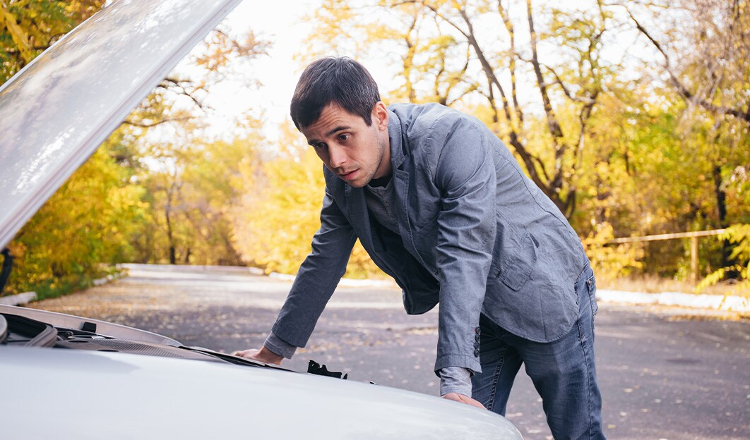 How to Jump Start a Car | West Broad Volkswagen in Richmond | Man Looking Under Hood of Vehicle