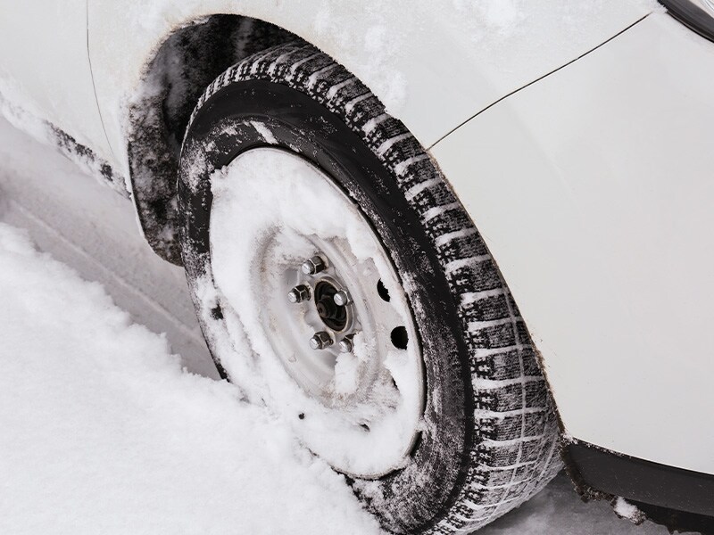 What Different Tire Options are Available at West Broad Volkswagen in Richmond | Close-UP Shot of Winter Tire Driving Through Thick Layer of Snow