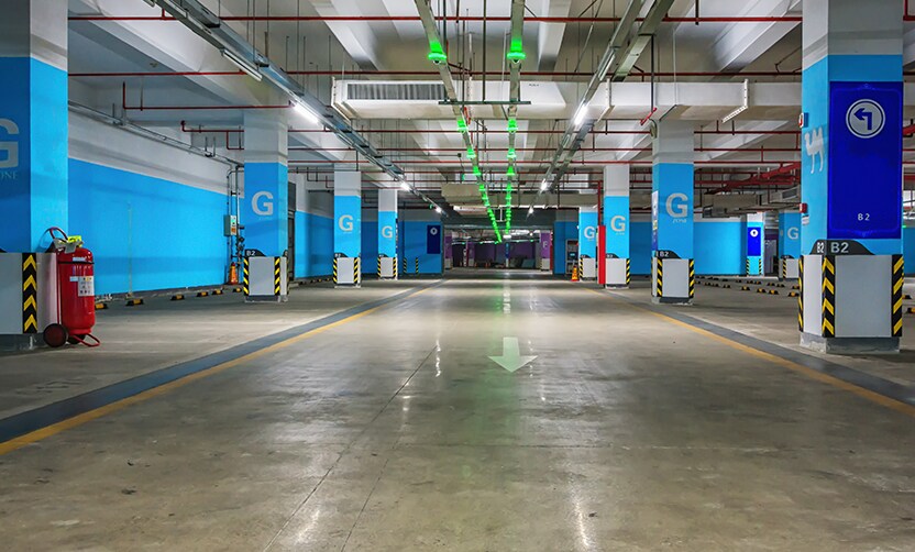 Extend the Life of Your Vehicle at West Broad VW in Richmond, VA | Parking garage with blue colored walls and green lights on the center of the roof