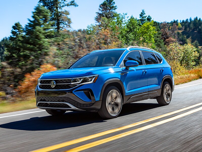 What Different Tire Options are Available at West Broad Volkswagen in Richmond | 2022 Volkswagen Taos Driving on Road Past Trees