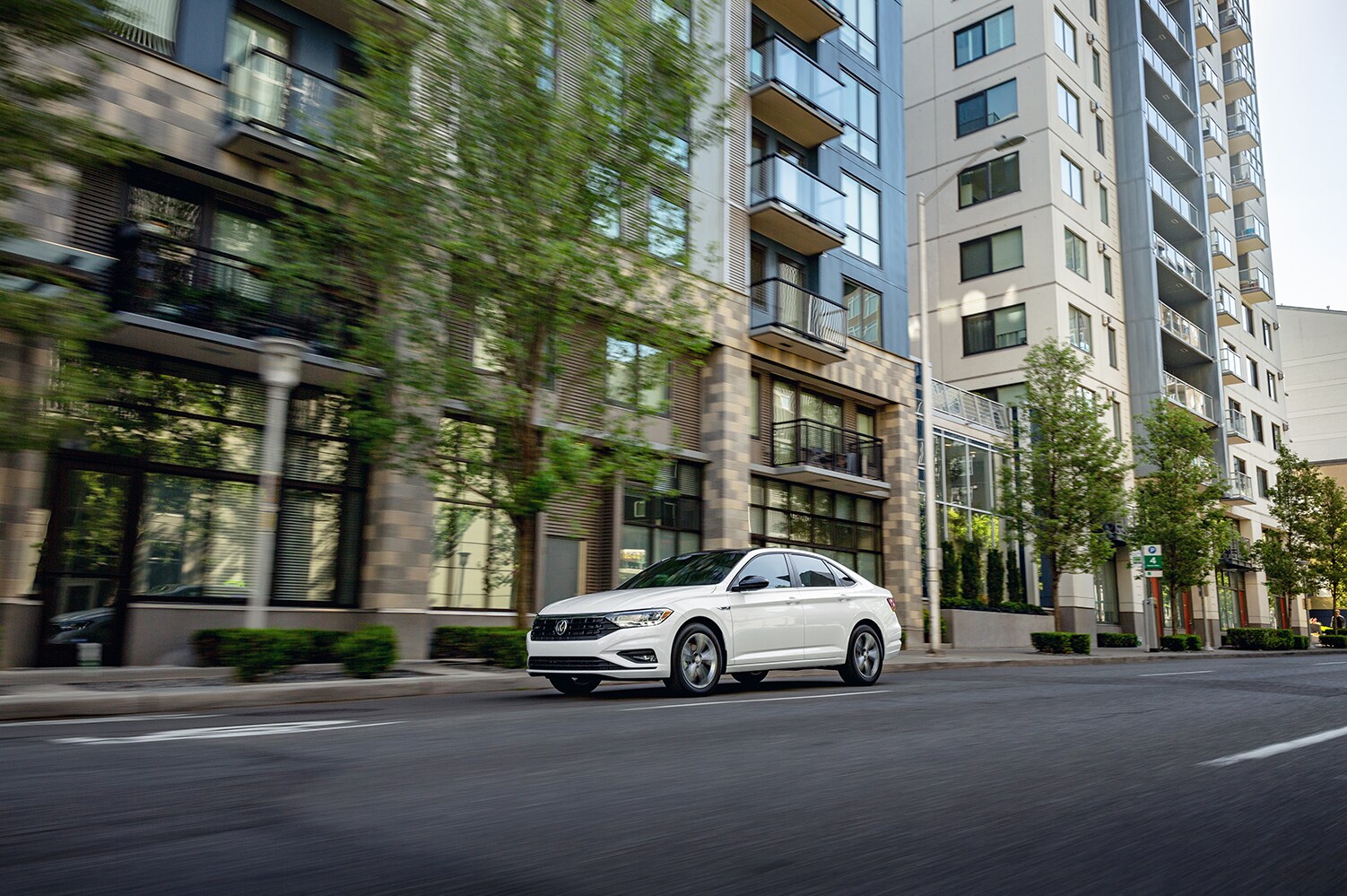 West Broad Volkswagen is a Volkswagen Dealership near Petersburg, VA | 2021 Volkswagen Jetta driving though city