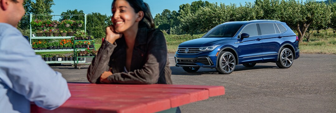 Battery Information at West Broad Volkswagen | Couple sit at table with Volkswagen in sight