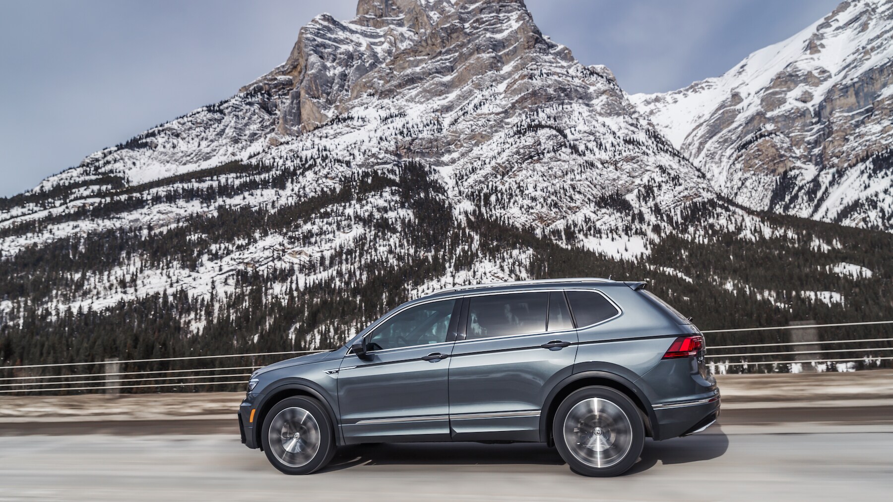 West Broad Volkswagen is a Volkswagen Dealership near Innsbrook, VA | 2020 Volkswagen Tiguan driving past snowy mountain