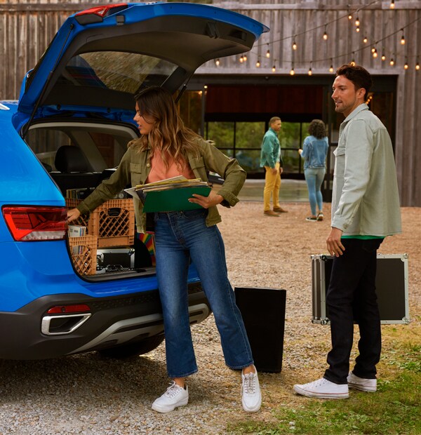 Basic Car Maintenance and Servicing Checklist | West Broad Volkswagen | A Couple Paking the Trunk of a 2022 Volkswagen Taos
