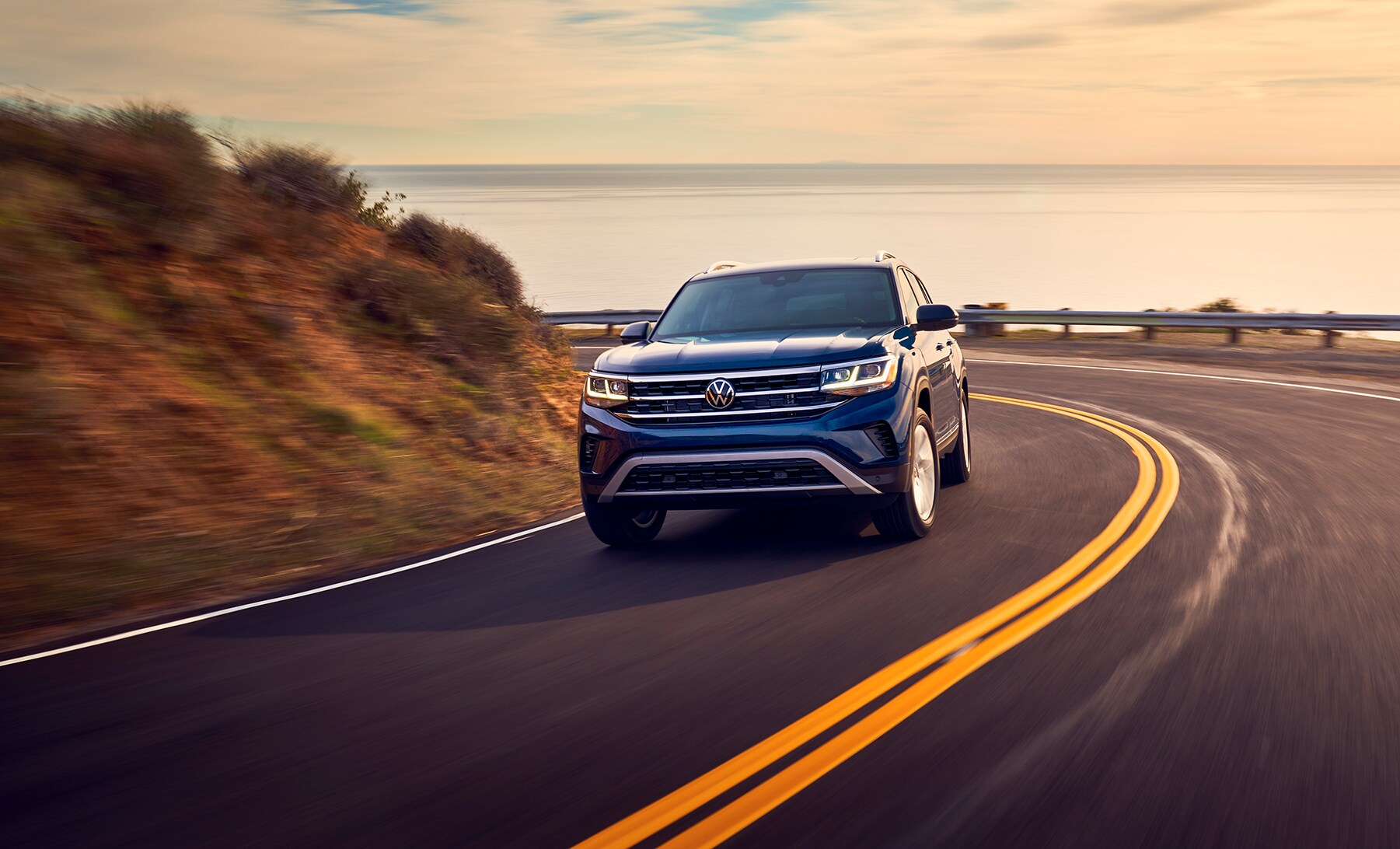 West Broad Volkswagen is a Volkswagen Dealership in Richmond near Ashland, VA | 2021 Volkswagen Atlas driving at sunset