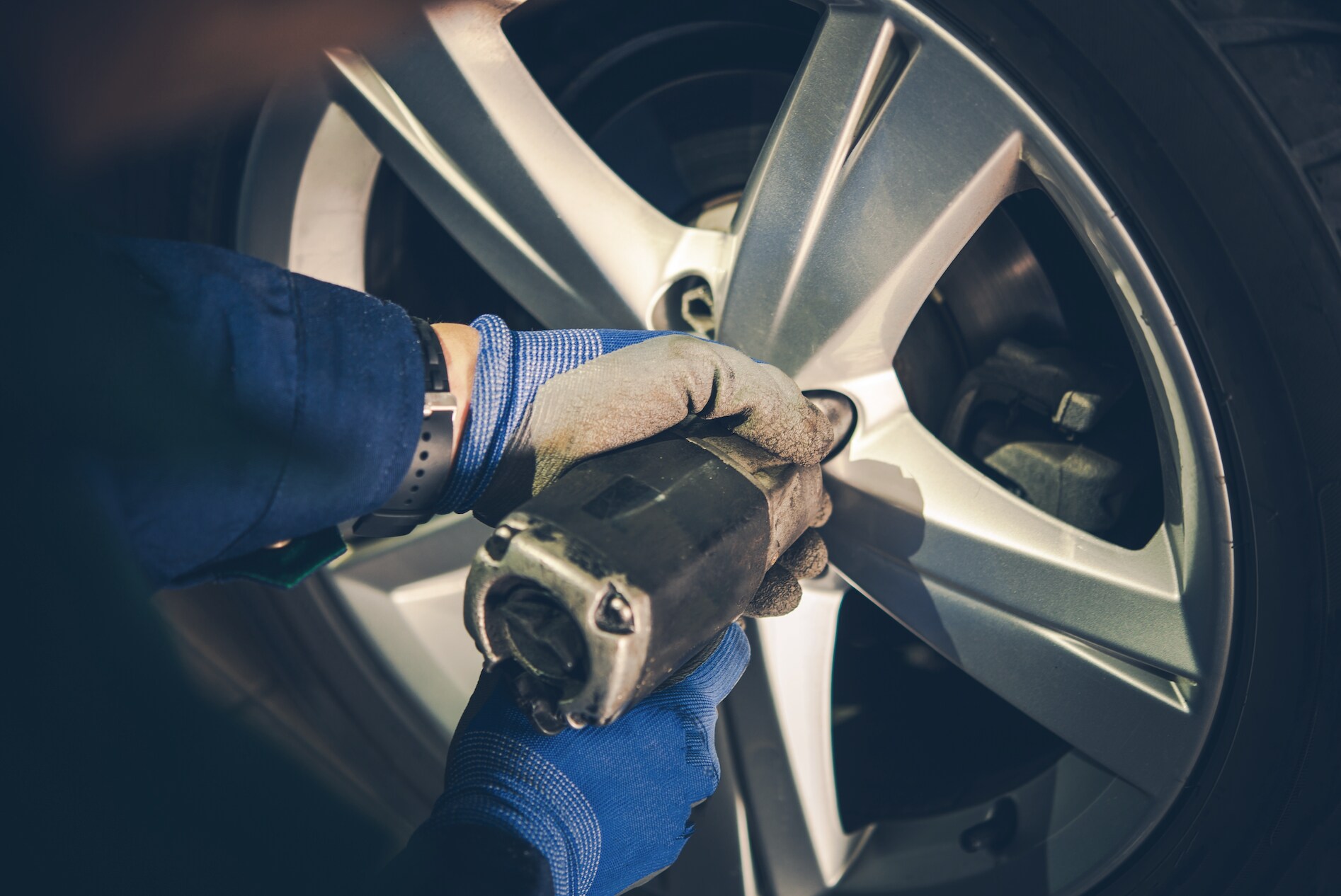 Mechanic aligning tires.