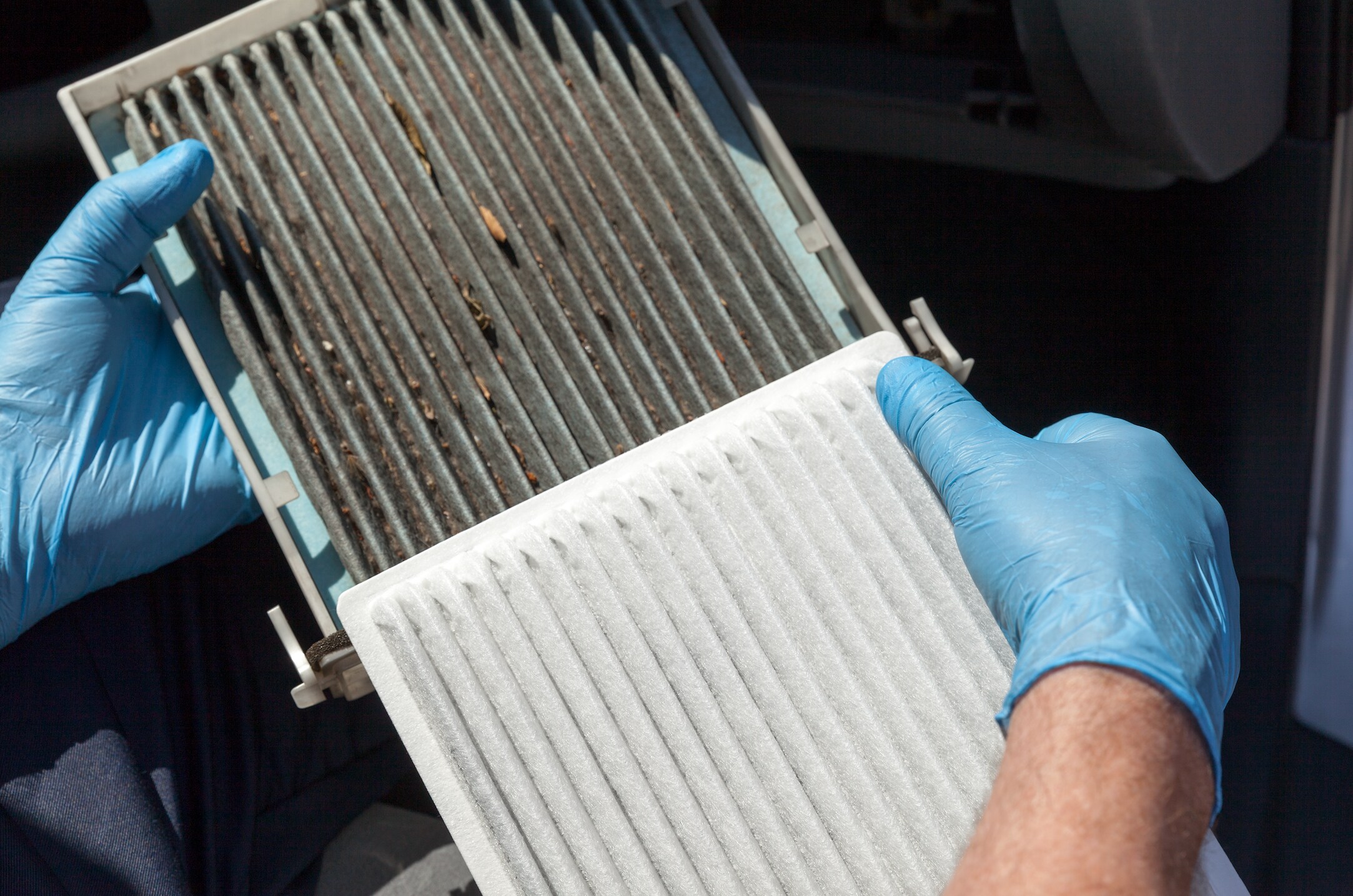 Side by side comparison of clean and dirty cabin air filters.