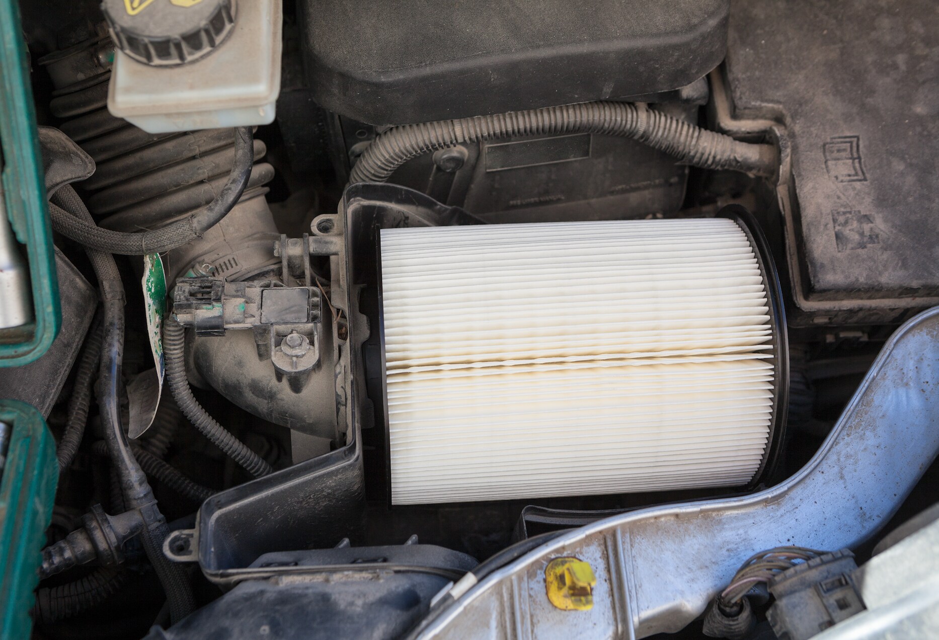 Clean engine air filter in vehicle.