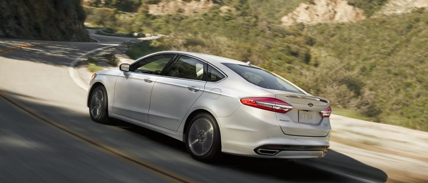 2022 White Ford Fusion Driving away through Mountains