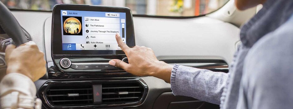 Test Drive a Ford with Ford SYNC Today A woman putting on music through Ford SYNC