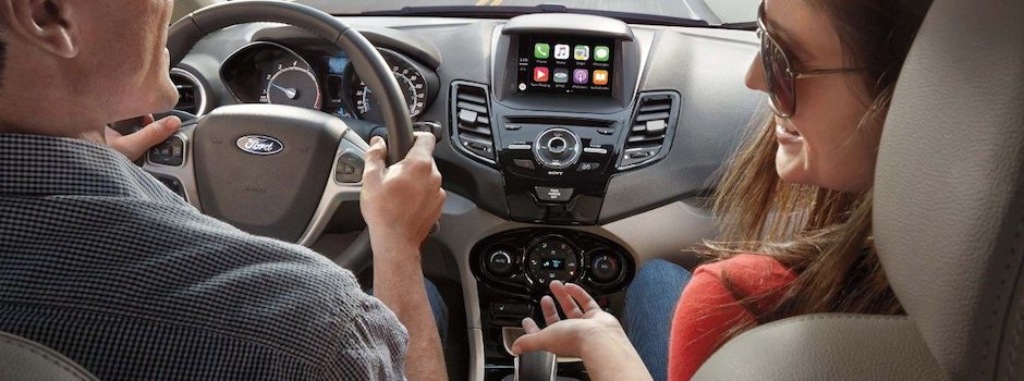 Which Ford Models Come with Ford SYNC.jpeg A couple driving in their Ford SYNC vehicle