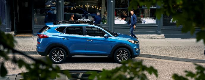 2020 Hyundai Tucson Ultimate Aqua Blue parked outside streetside cafe_2.JPG