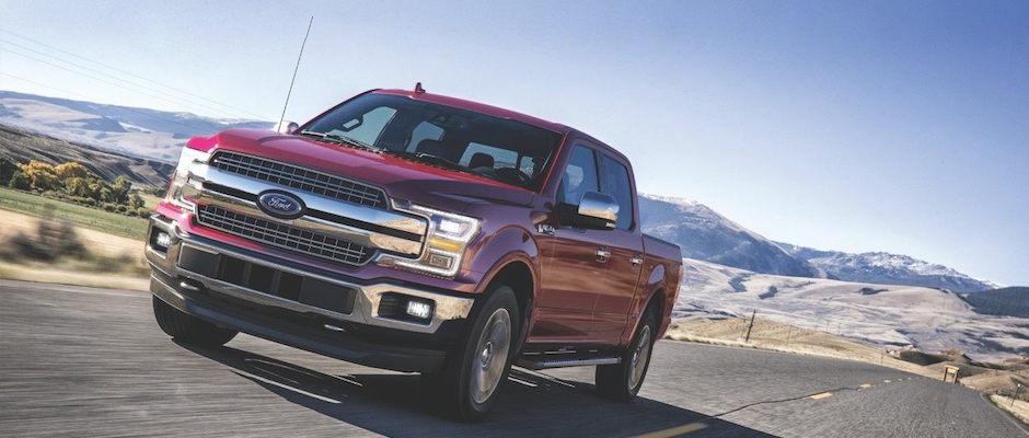 Test Drive a Ford Truck Today A red 2018 Ford driving down an open highway