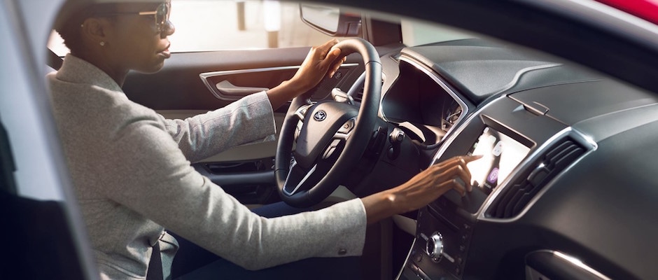2019 Ford Edge Design and Technology A woman using the technology features in her 2019 Ford Edge