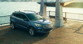 Ford Escape Model Research A blue Ford Escape parked by the water