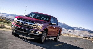 Ford F-150 Model Research A Ford F-150 driving past the mountains
