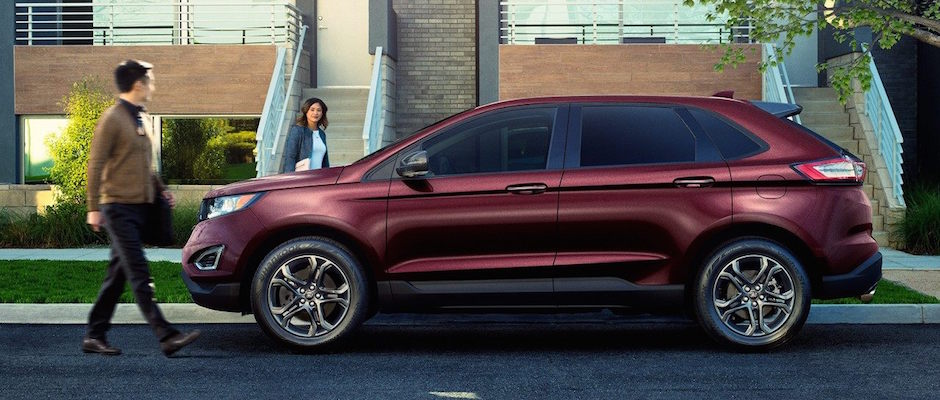 2018 Ford Edge A couple walking to their red 2018 Ford Edge