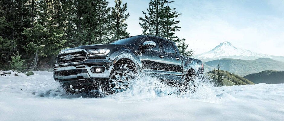 2019 Ford Ranger First Look Power & Capability A black 2019 Ford Ranger driving through the snow
