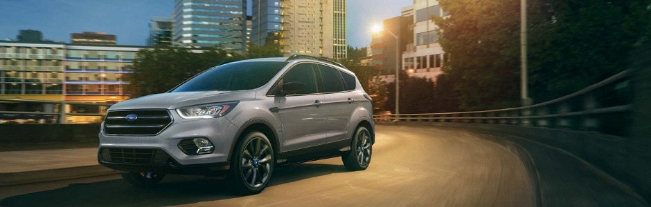2018 Ford Escape Model Review A 2018 Ford Escape driving through the city at night