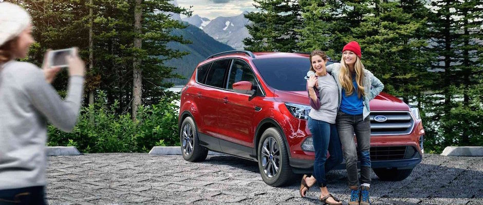 2018 Ford Escape A mom and daughter taking a picture in front of their 2018 Ford Escape
