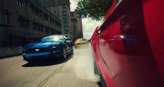 Ford Mustang Model Research Ford Mustangs driving through the city streets