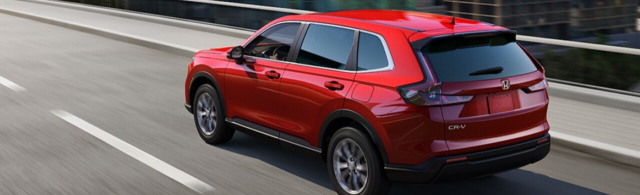 Discover-the-2025-Honda-CR-V-Hybrid-Efficiency-%26-Power1.png A driver experiencing the smooth performance of the 2025 Honda CR-V Hybrid.