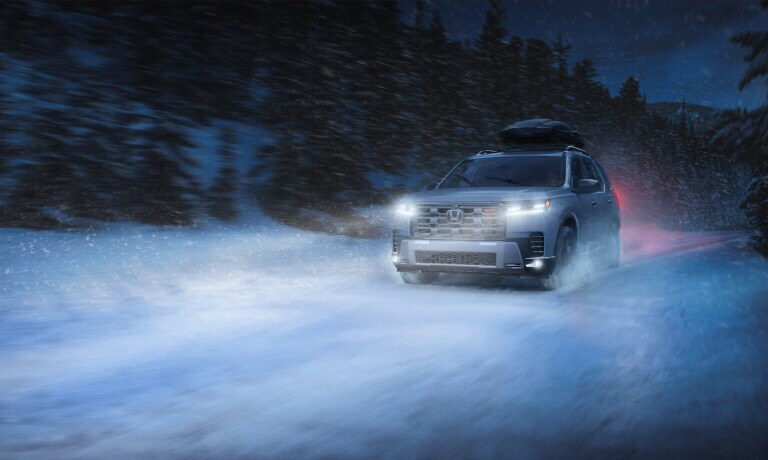 2026 Honda Pilot driving in snow at night