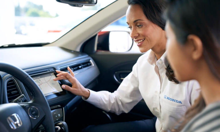 Employee showing customer Honda technology