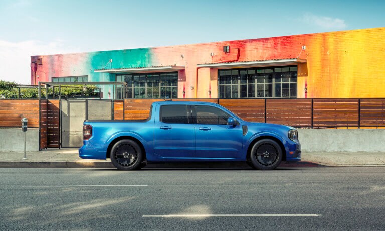 2026 Ford Maverick side view parked by colorful wall