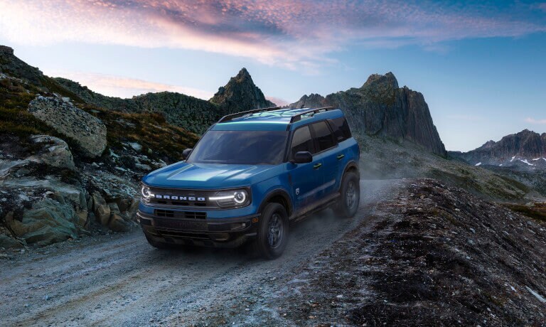 2026 Ford Bronco driving in mountains in sunrise
