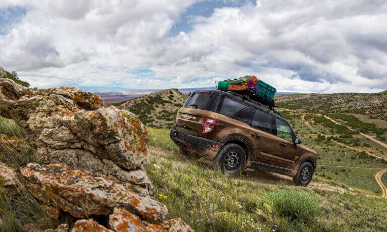 2026 Ford Bronco with luggage in grassy hills
