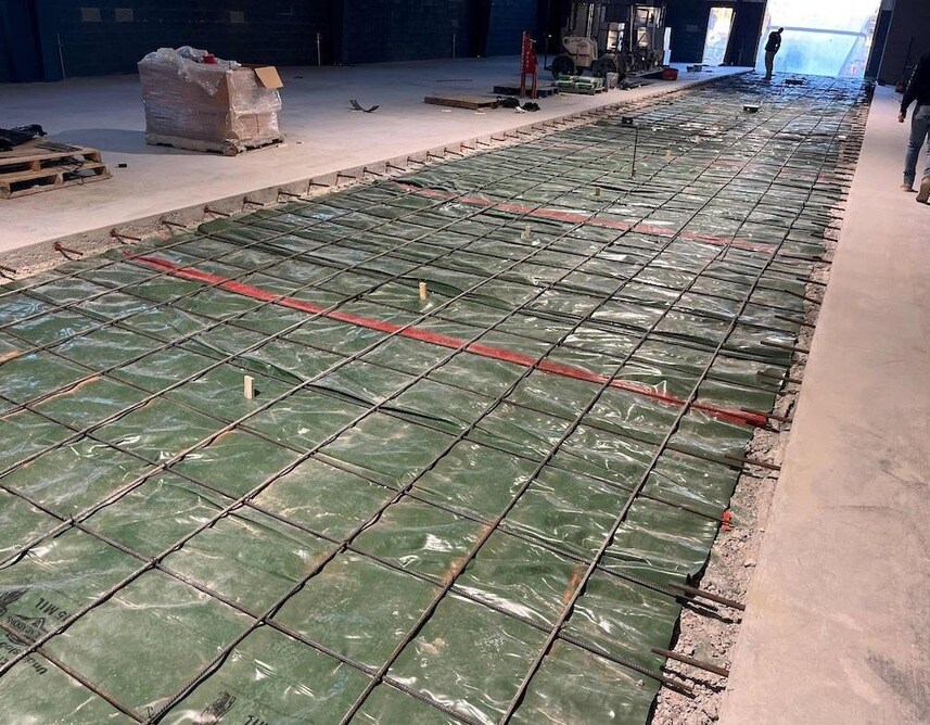 Underslab Vapor Barrier And Rebar Installation In Progress. Underslab Vapor Barrier And Rebar Installation In Progress.