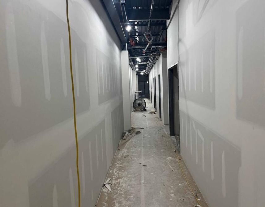 Interior Drywall Finishing In Progress At Second Floor Hallway. Interior Drywall Finishing In Progress At Second Floor Hallway.