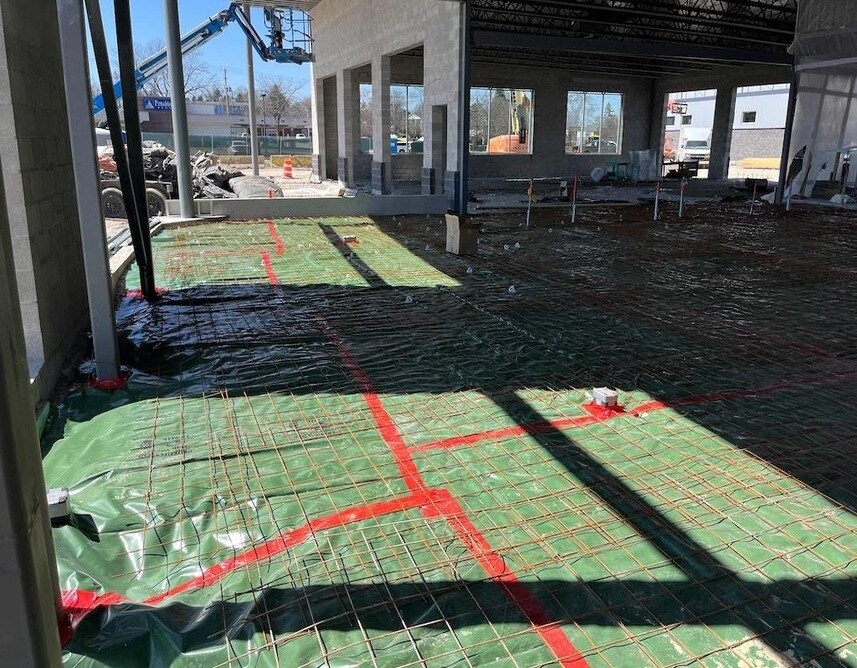 Underslab Vapor Barrier And Rebar Installation In Progress. Underslab Vapor Barrier And Rebar Installation In Progress.