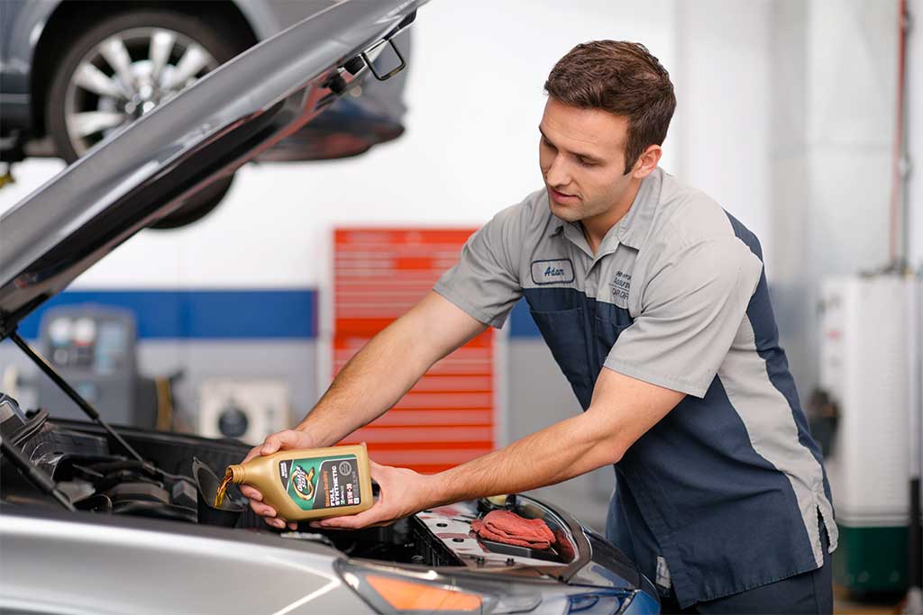 oil-change.jpg Hyundai Service Technician adding oil to engine