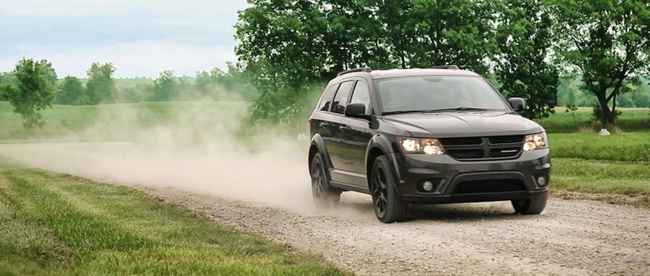 2018 Dodge Journey Engine Options A 2018 Dodge Journey driving down a dirt road