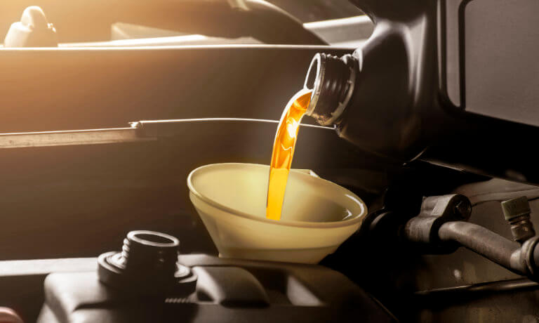 Oil being poured into funnel