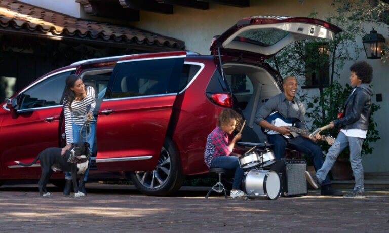 2019 Chrysler Pacifica exterior with family outside home playing music
