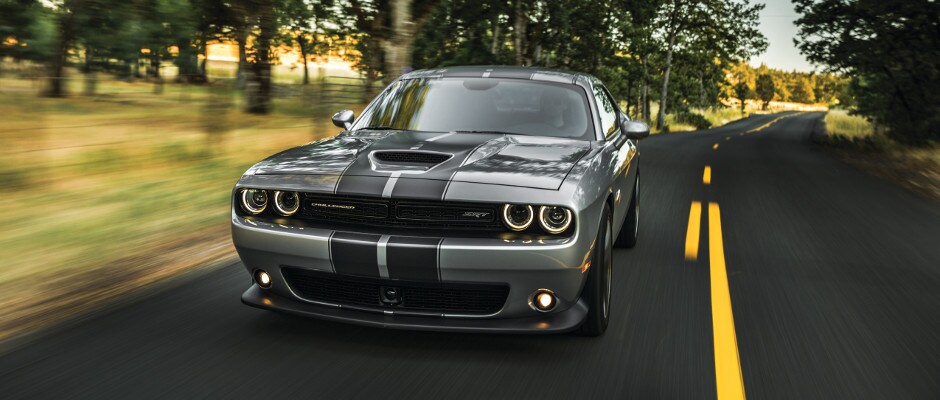 Finance with W-K CDJR Today A Dodge Challenger driving down a country road