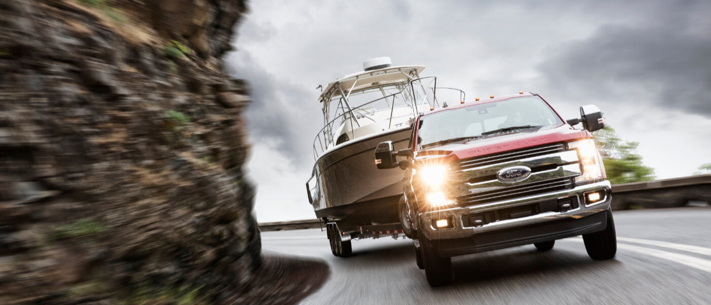 2019 Ford F250 exterior driving around mountain turn towing boat