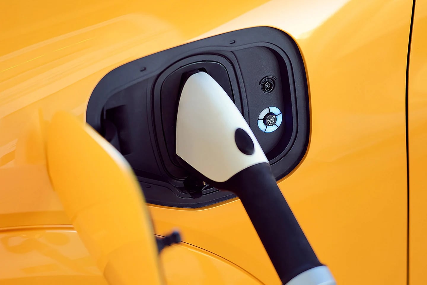 plug in.webp Close up of a yellow Ford Mustang Mach-E being charged