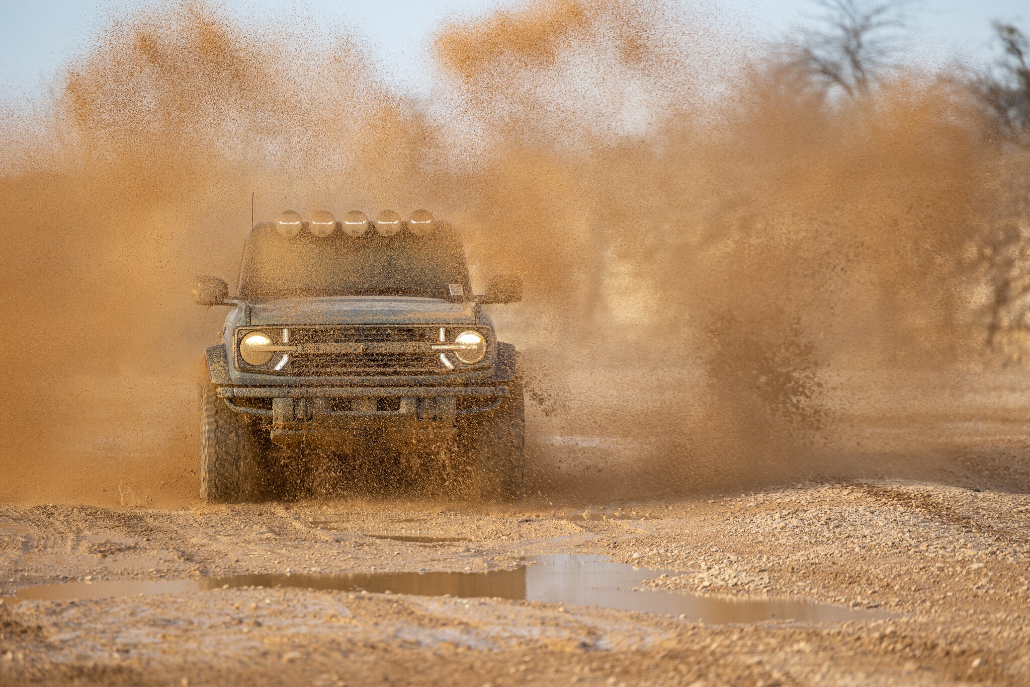 Blue RTR Bronco driving through dusty Utah terrain