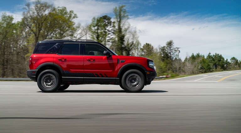 Red Bronco Sport RTR parked among trees
