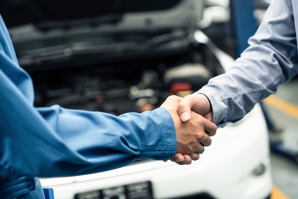 Young Ford of Ogden service technician shaking hands with a customer